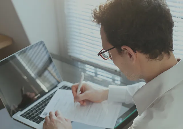 Reviewing a job application on a laptop